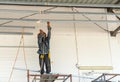 Worker welding steel bar support ceiling at height Royalty Free Stock Photo