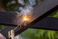 Worker welding steel pipe in construction site Royalty Free Stock Photo