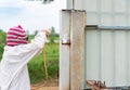 Worker welding steel pole for fence