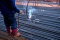 Worker welding steel rebar for reinforcement concrete in the construction site