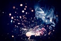 Worker welding steel with sparks using mig mag welder