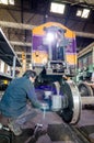 Worker welding train in the factory.