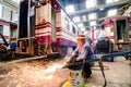 Worker welding train in the factory.