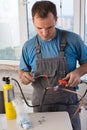 Worker welds copper tube oxyfuel gas