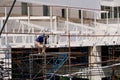 Worker welds on top of a scaffold