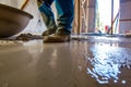 worker wetting the floor before pouring concrete