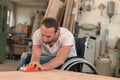 Worker in wheelchair in a carpenter`s workshop Royalty Free Stock Photo