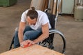 Worker in wheelchair in a carpenter`s workshop Royalty Free Stock Photo