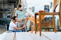 Worker in wheelchair in a carpenters workshop with his colleagu Royalty Free Stock Photo