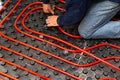 Worker who instal tubes of radiant underfloor heating installation Royalty Free Stock Photo