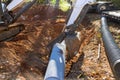 Worker who operate a tractor to lift sewage pipes in the ground are preparing to install underground before putting Royalty Free Stock Photo