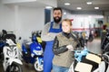 Worker with woman customer in motorcycle workshop