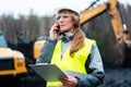 Worker woman in open-cast mining using phone Royalty Free Stock Photo