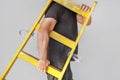 Worker with wooden ladder