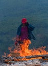 Worker working on fire to dry clay pots