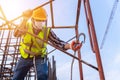 Worker working at height equipment constructive at construction site. Fall arrestor device for worker with hooks for safety body Royalty Free Stock Photo