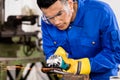 Worker working on metal with grinder tool