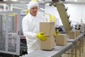 Worker working on packing line in factory Royalty Free Stock Photo