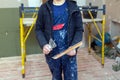 Worker is working with palette-knife for flattening the ceiling from wooden platform in room of apartment is inder Royalty Free Stock Photo