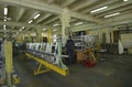 Worker working with a part of a fuselage of light plane at the assembly shop