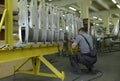 Worker working with a pneumatic drill assembling a fuselage of light plane at the assembly shop