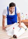Worker working on wallpaper during refurbishment Royalty Free Stock Photo