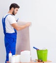 Worker working on wallpaper during refurbishment Royalty Free Stock Photo