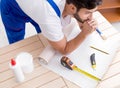 Worker working on wallpaper during refurbishment Royalty Free Stock Photo