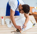 Worker working on wallpaper during refurbishment Royalty Free Stock Photo