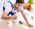 Worker working on wallpaper during refurbishment Royalty Free Stock Photo