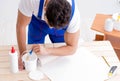 Worker working on wallpaper during refurbishment Royalty Free Stock Photo