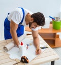 Worker working on wallpaper during refurbishment Royalty Free Stock Photo