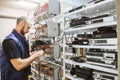 Worker works on the control panel in the data center. Specialist connects coaxial television wires in the rack of the TV station Royalty Free Stock Photo