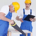 Worker works with handsaw Royalty Free Stock Photo