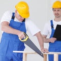 Worker works with handsaw Royalty Free Stock Photo