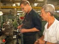 a worker works on a lathe in a Soviet era machine shop Royalty Free Stock Photo