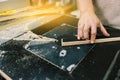 Worker works on woodworking equipment. Manufacturing of wooden furniture. Workshop for the production of wooden products Royalty Free Stock Photo