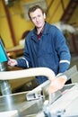 Worker at workshop with circ saw Royalty Free Stock Photo