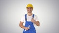 Worker with wrench showing thumb up and smiling to camera on gra Royalty Free Stock Photo