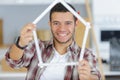 Worker with yardstick- house in front white background