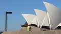 Worker with yellow reflective vest watching the Sydney Opera House dome