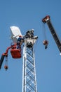 Workers on the aerial platform with the help of a crane carry out the installation of the wind generator