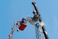 Workers on the aerial platform with the help of a crane carry out the installation of the wind generator