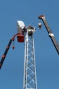 Workers on the aerial platform with the help of a crane carry out the installation of the wind generator