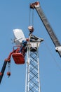 Workers on the aerial platform with the help of a crane carry out the installation of the wind generator