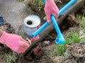 Workers apply glue to water pipes in the lawn
