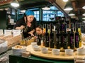 Workers arrange vinegars at Pike Place Public Market, Seattle