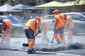 Workers asphalting repair the road on the street of city