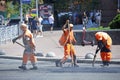 Workers asphalting repair the road on the street of city