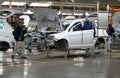 Workers assemble a car on assembly line in car factory